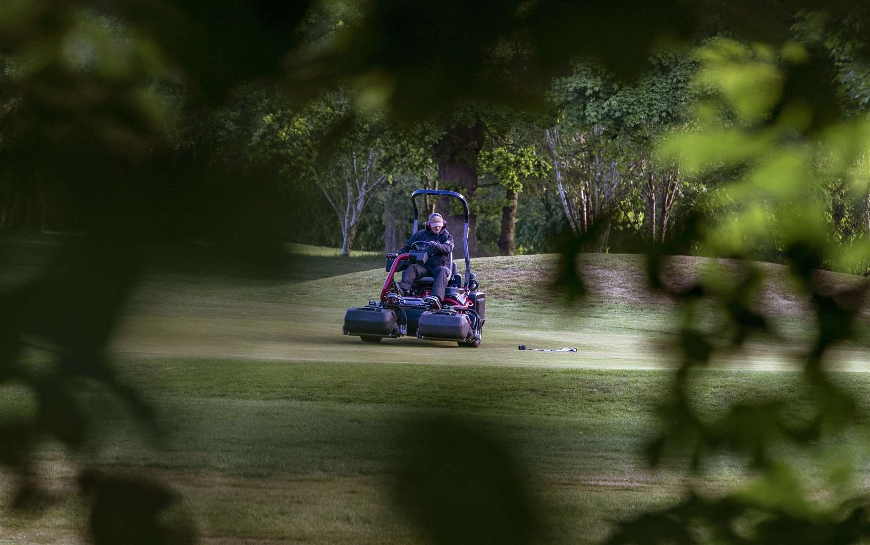 The green keeper at Allerton Manor golf course in Liverpool mows the grass on the 13th green after the lifting of lockdown restrictions (Peter Byrne/PA)