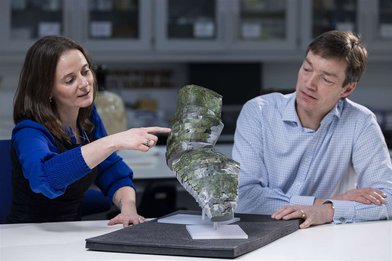 Conservator Bethan Bryan and curator Fraser Hunter with the arm guard (Duncan McGlynn/National Museums Scotland/PA)