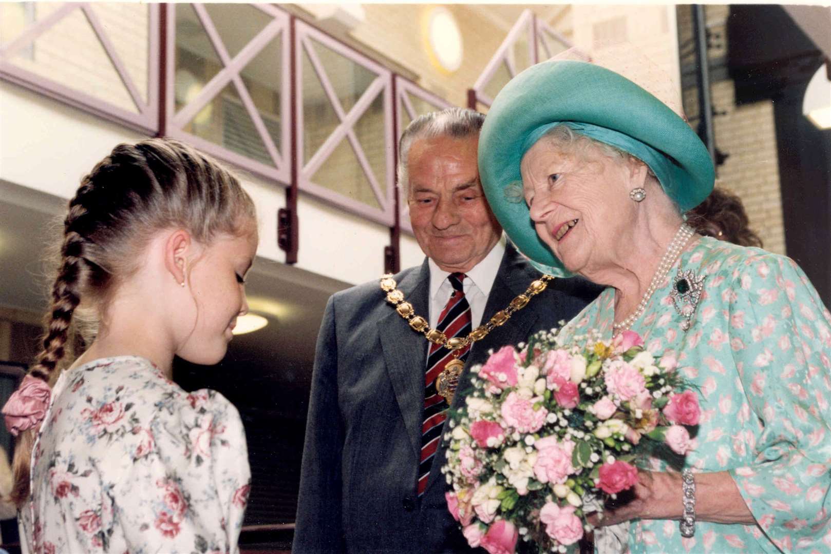 Nicola Clark, 10, presented the Queen Mother with a posy when she visited Sunny Corner sheltered housing scheme for the elderly at Aylcliffe, Dover, in July 1995