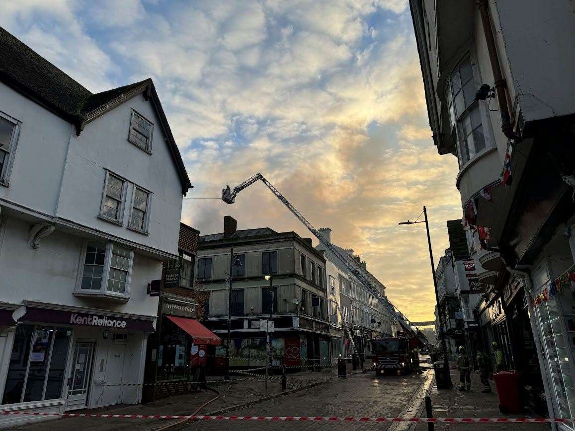 Crews remain at the scene of the former Debenhams fire in Canterbury this afternoon