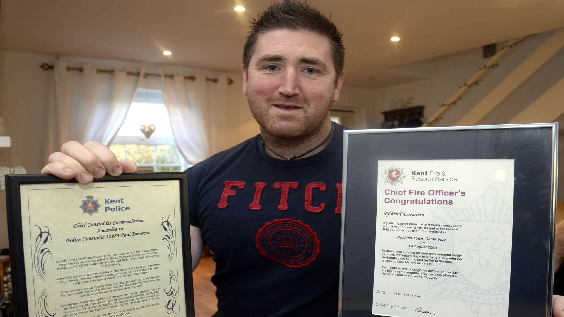 Police officer Paul Donovan with two of his awards