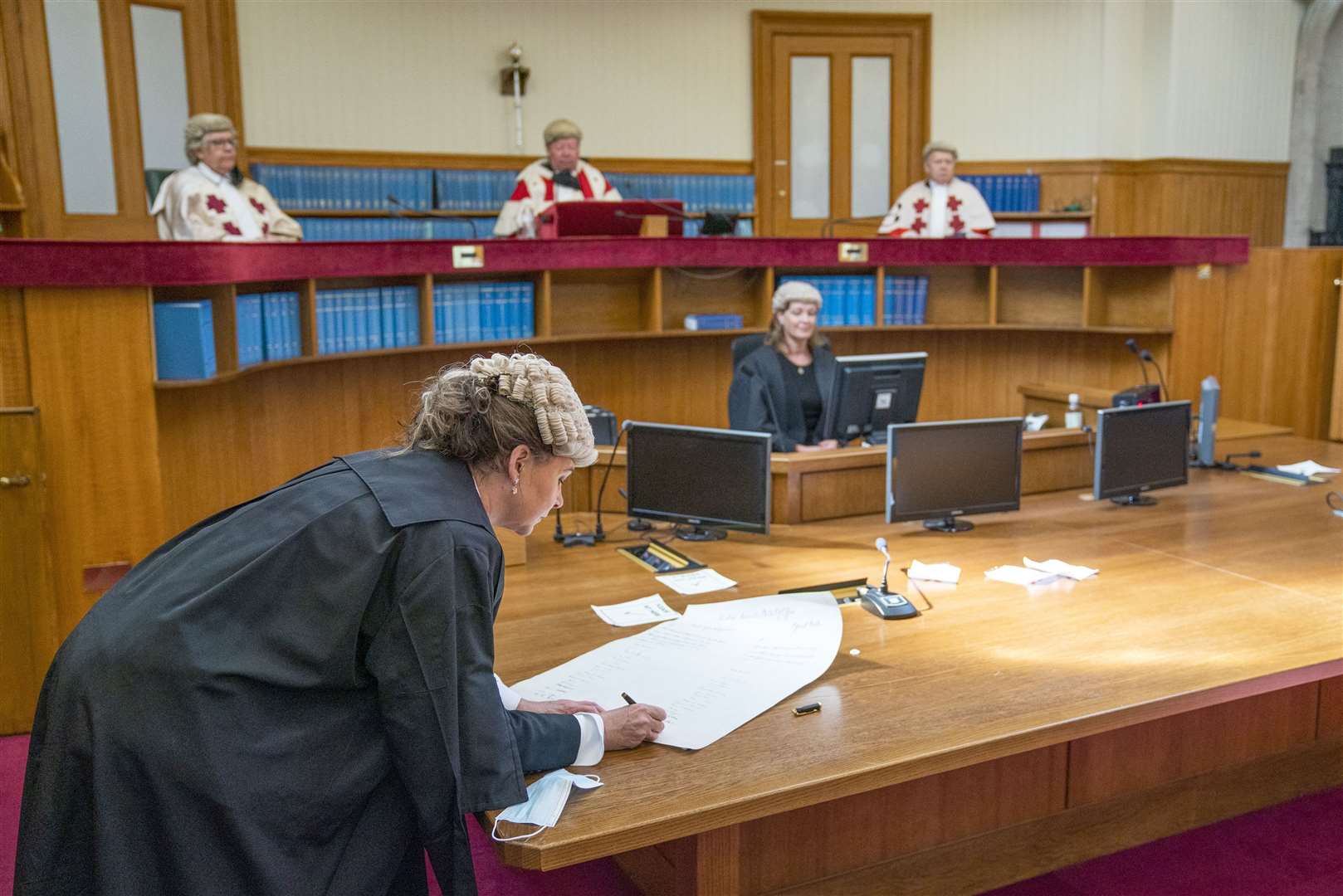 Lord Advocate Dorothy Bain QC signs the parchment during a swearing in ceremony before Lord Carloway at the Court of Session in Edinburgh (Jane Barlow/PA)