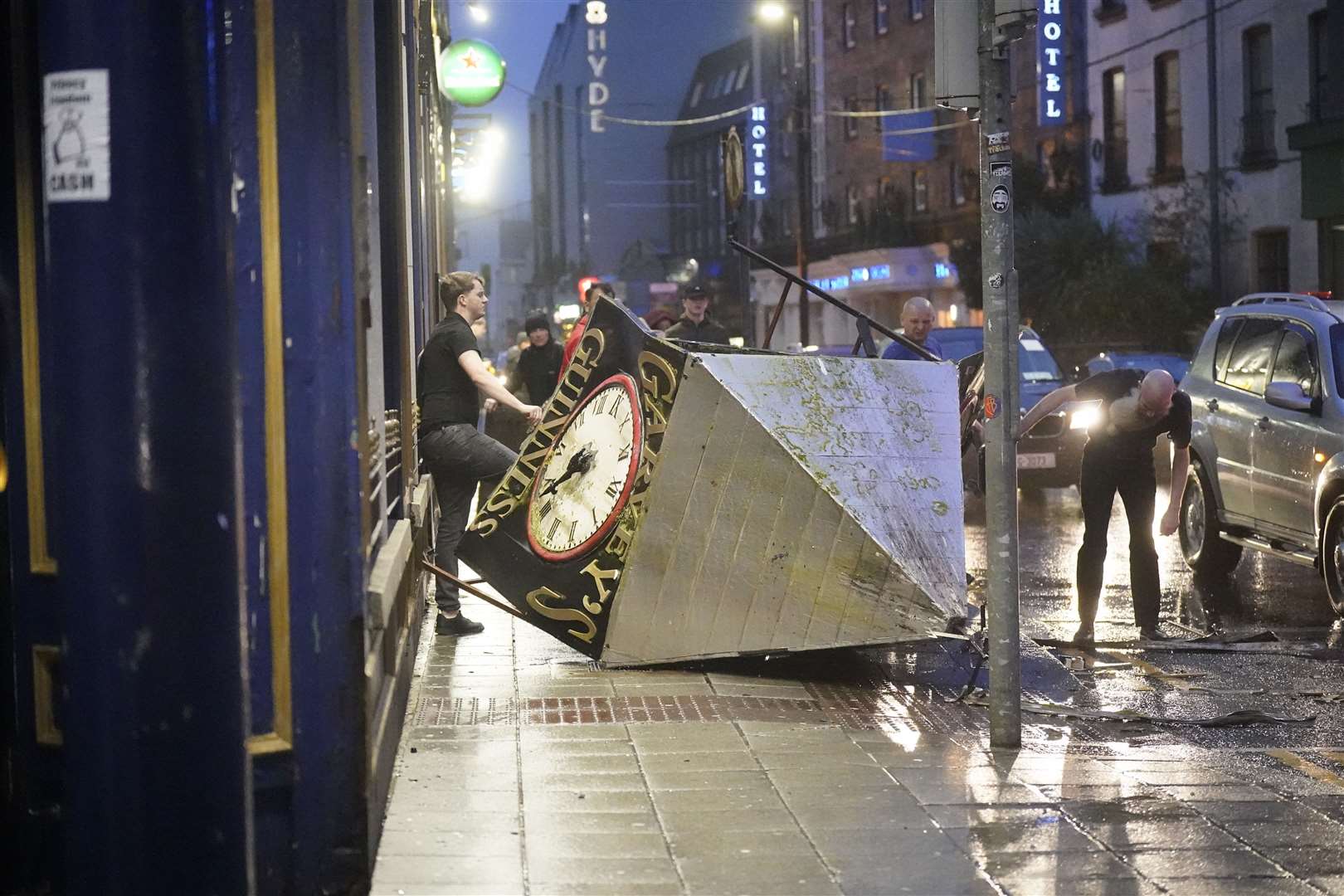 A clock tower falls to the ground in Eyre Square, Galway, during Storm Isha (Niall Carson/PA)