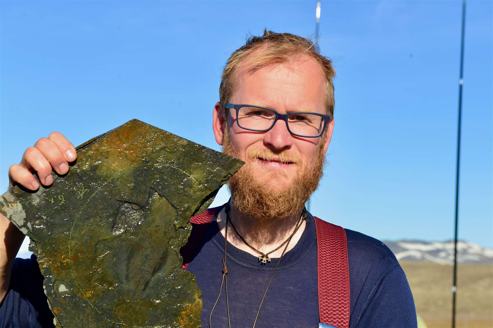 Jakob Vinther at the Sirius Passet locality in Greenland with a specimen of Timorebestia (Dr Jakob Vinther/University of Bristol)