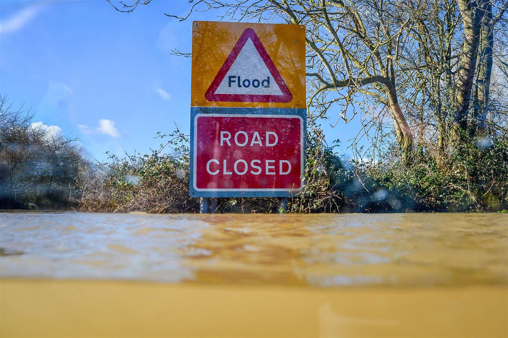 A road closed sign pokes out above floodwater and alerts motorists of flooding on the B4213 between Lower Apperlay and Tirley in Gloucestershire (Ben Birchall/PA)