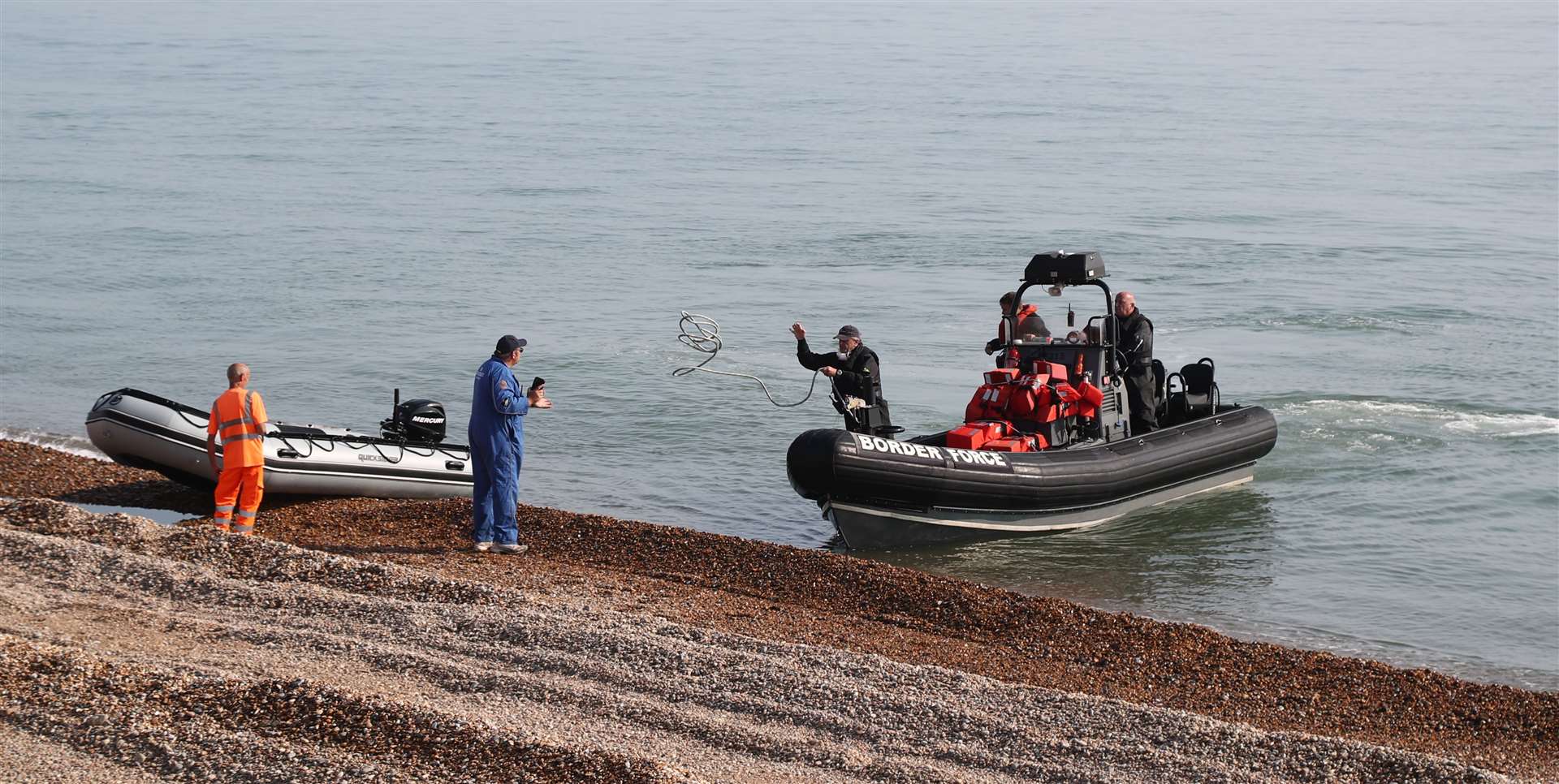 Border Force staff recover the inflatable boat at Kingsdown beach (Gareth Fuller/PA)