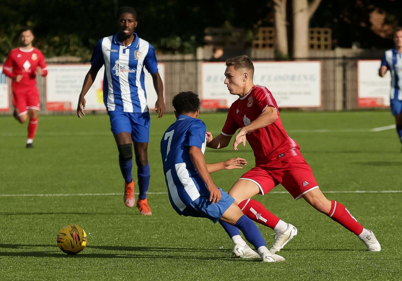 Whitstable midfielder Josh Oliver sprints around Jay Simpson. Picture: Les Biggs