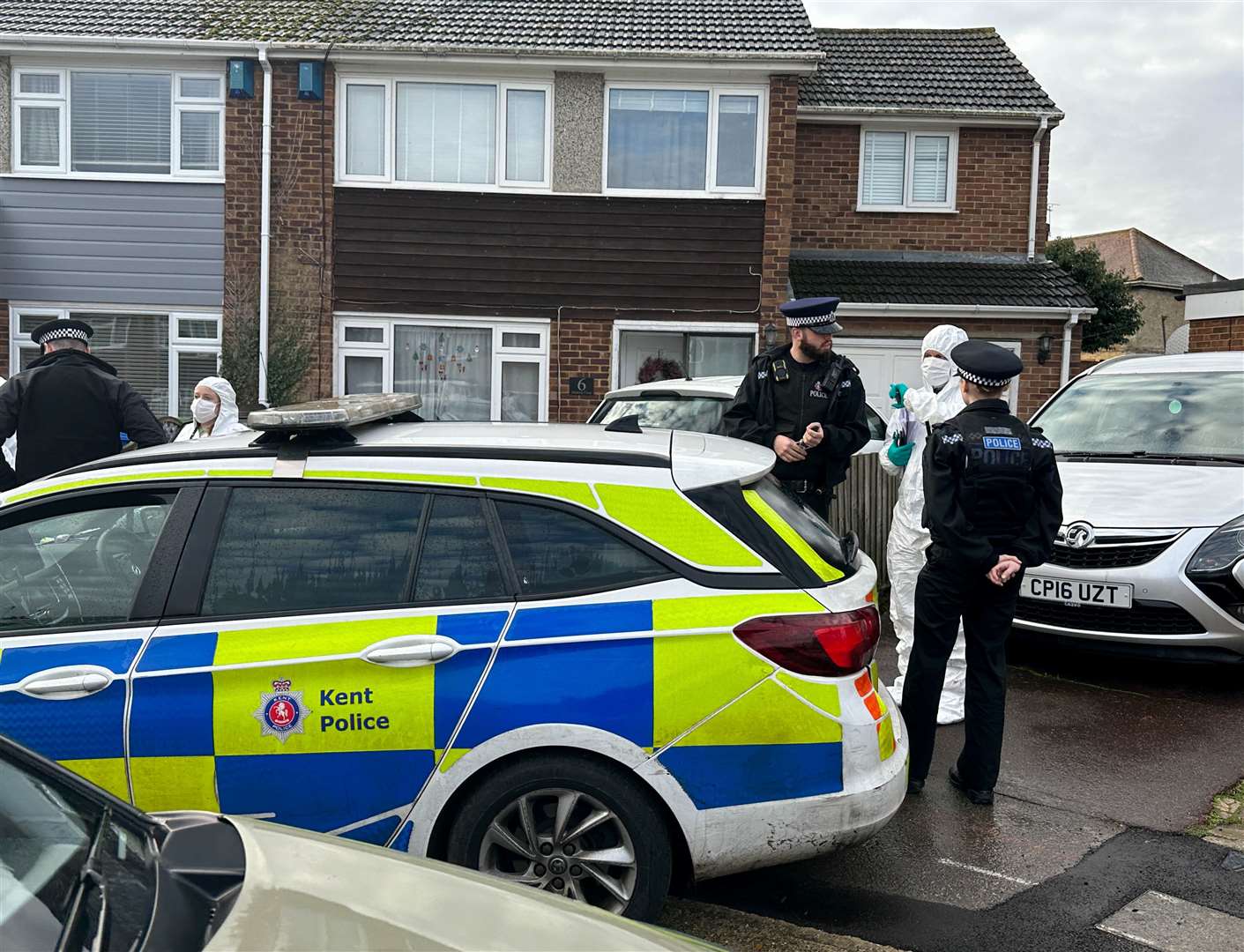 Police officers, including forensics, outside the house in Medway Close that Rohan Daniels shared with David Perry. Pictures: UKNIP