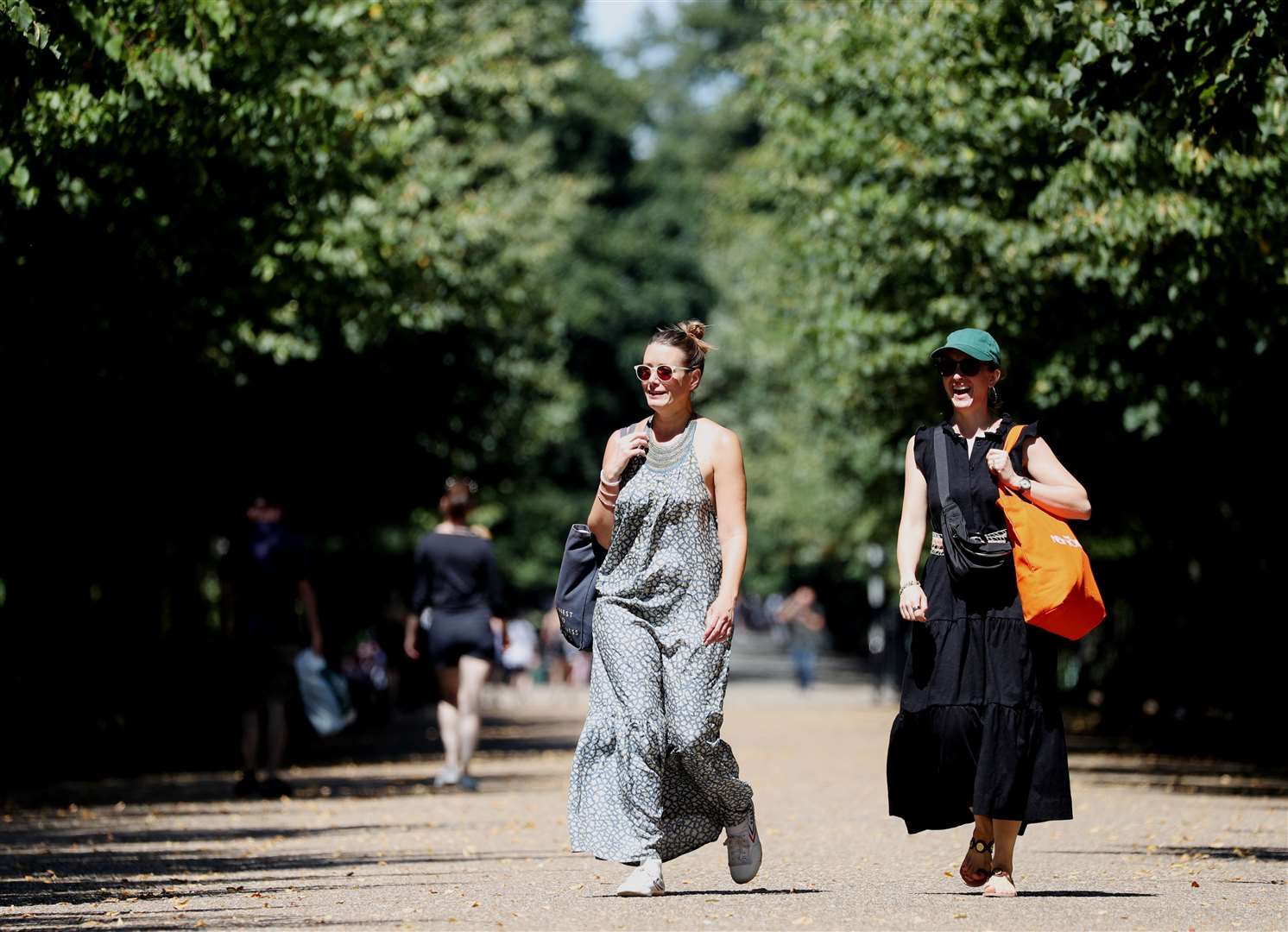 Visitors are bathed in sunshine as they walk through Regent’s Park, London.