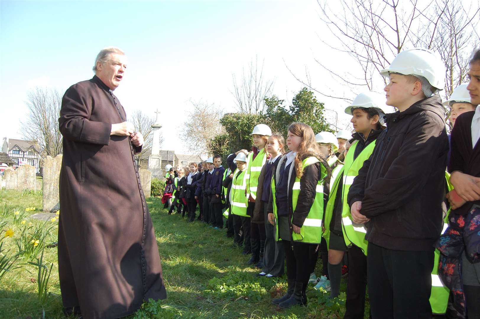 Vicar Laurence Smith addresses pupils from Lawn Primary School outside St Botolph's Church in Northfleet.