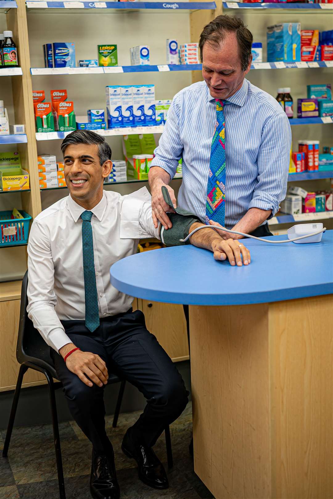 Prime Minister Rishi Sunak has his blood pressure checked by pharmacist Peter Baillie (Ben Birchall/PA)