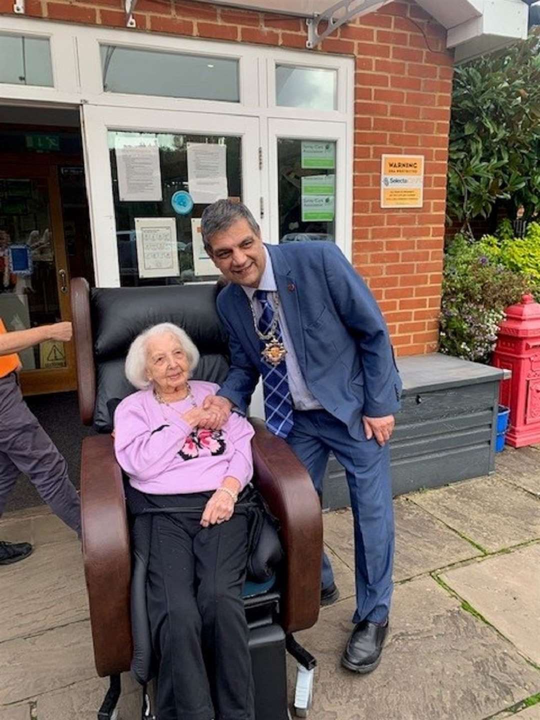 Birthday girl Joyce Tofts shakes hands with the Mayor of Woking on her 102nd birthday (Princess Christian Care Centre/PA)