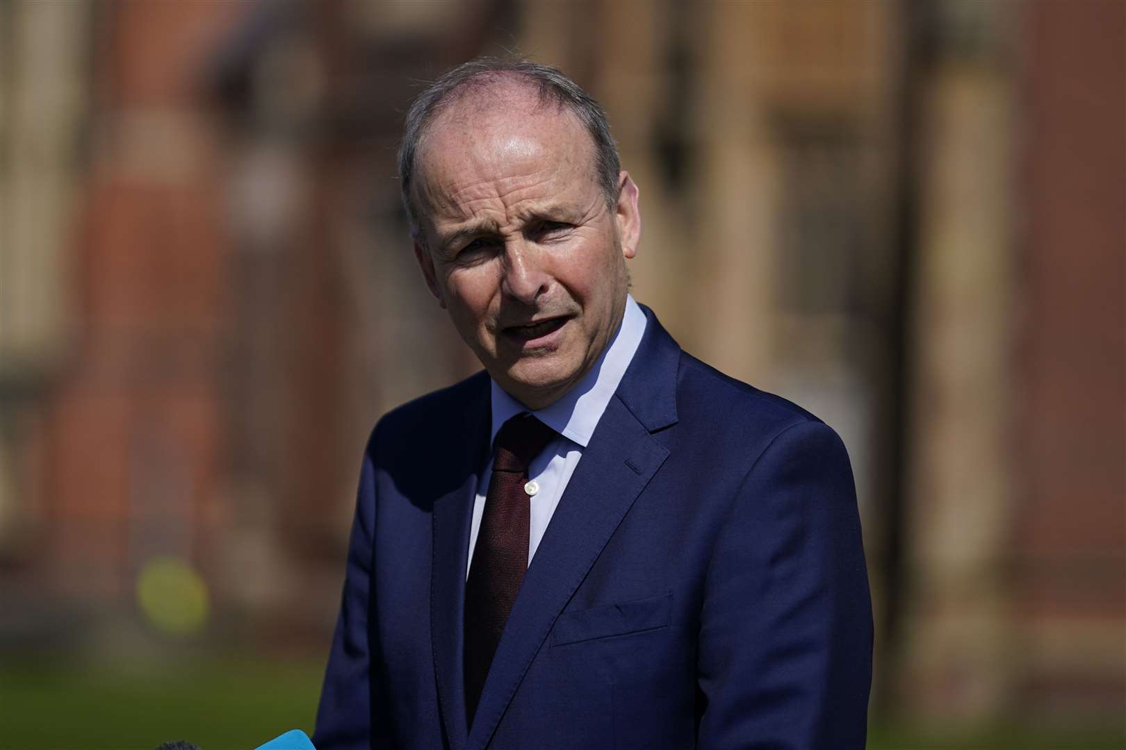 Tanaiste Micheal Martin talking to the media in the grounds of Queen’s University (Niall Carson/PA)