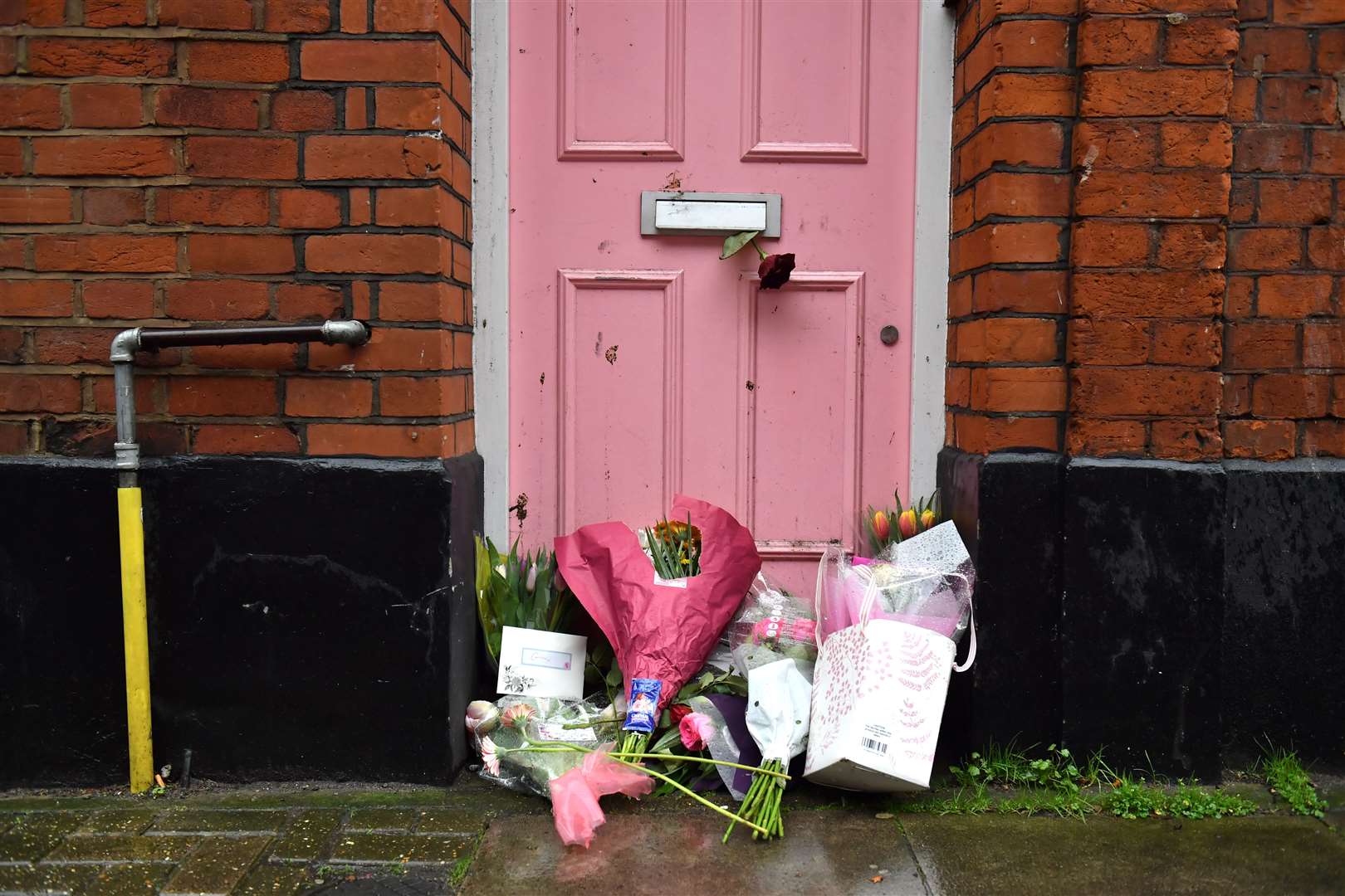 Floral tributes placed outside Caroline Flack’s former home in North London in the aftermath of her death (Dominic Lipinski/PA)