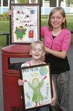 Sophia Rosco, seven, and Rebecca Pavitt, 11 hold up their winning pictures.