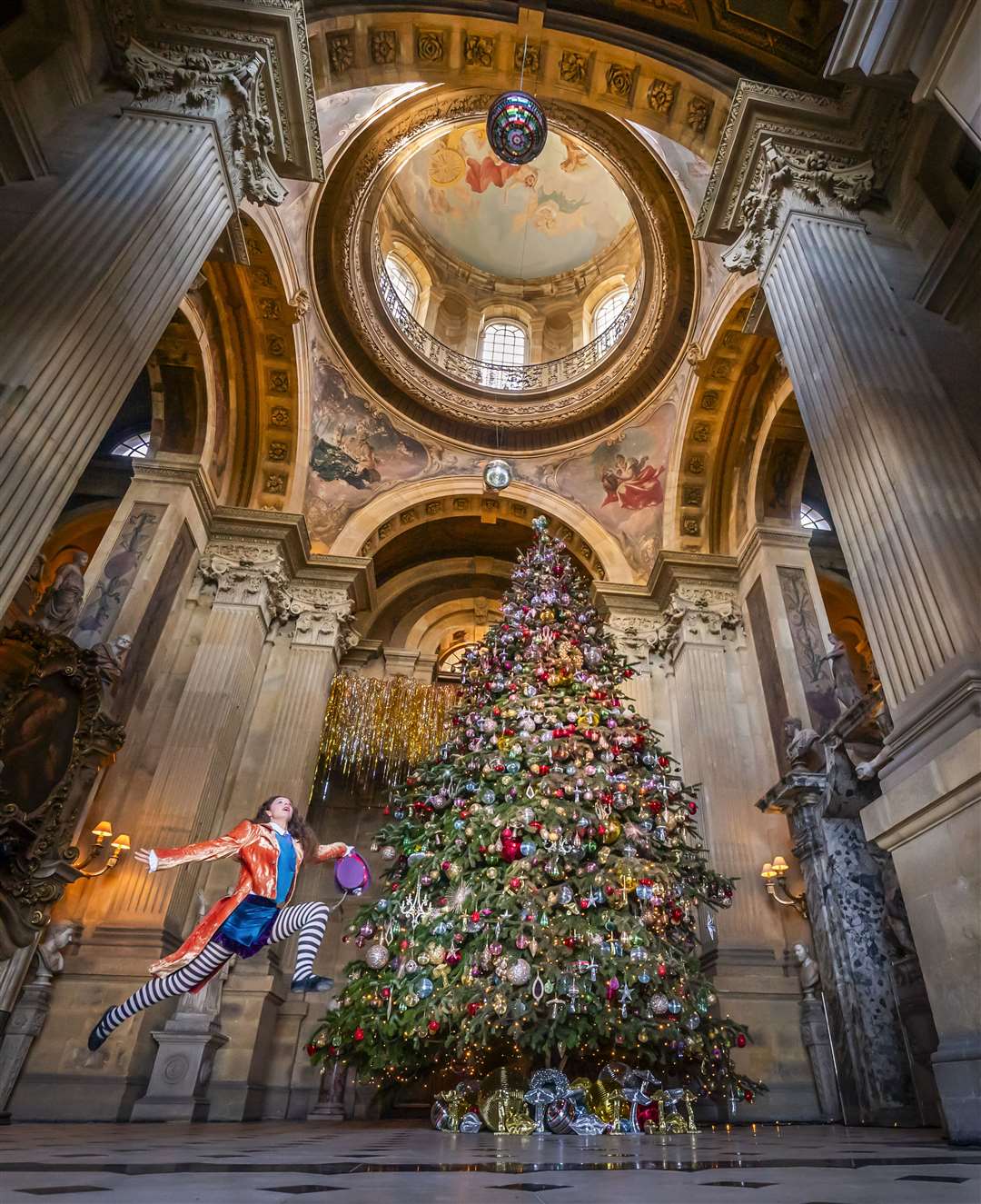 Poppy Avison-Fell dressed as the Mad Hatter at the unveiling of a 27ft Christmas tree in Castle Howard’s Great Hall in North Yorkshire (Danny Lawson/PA)