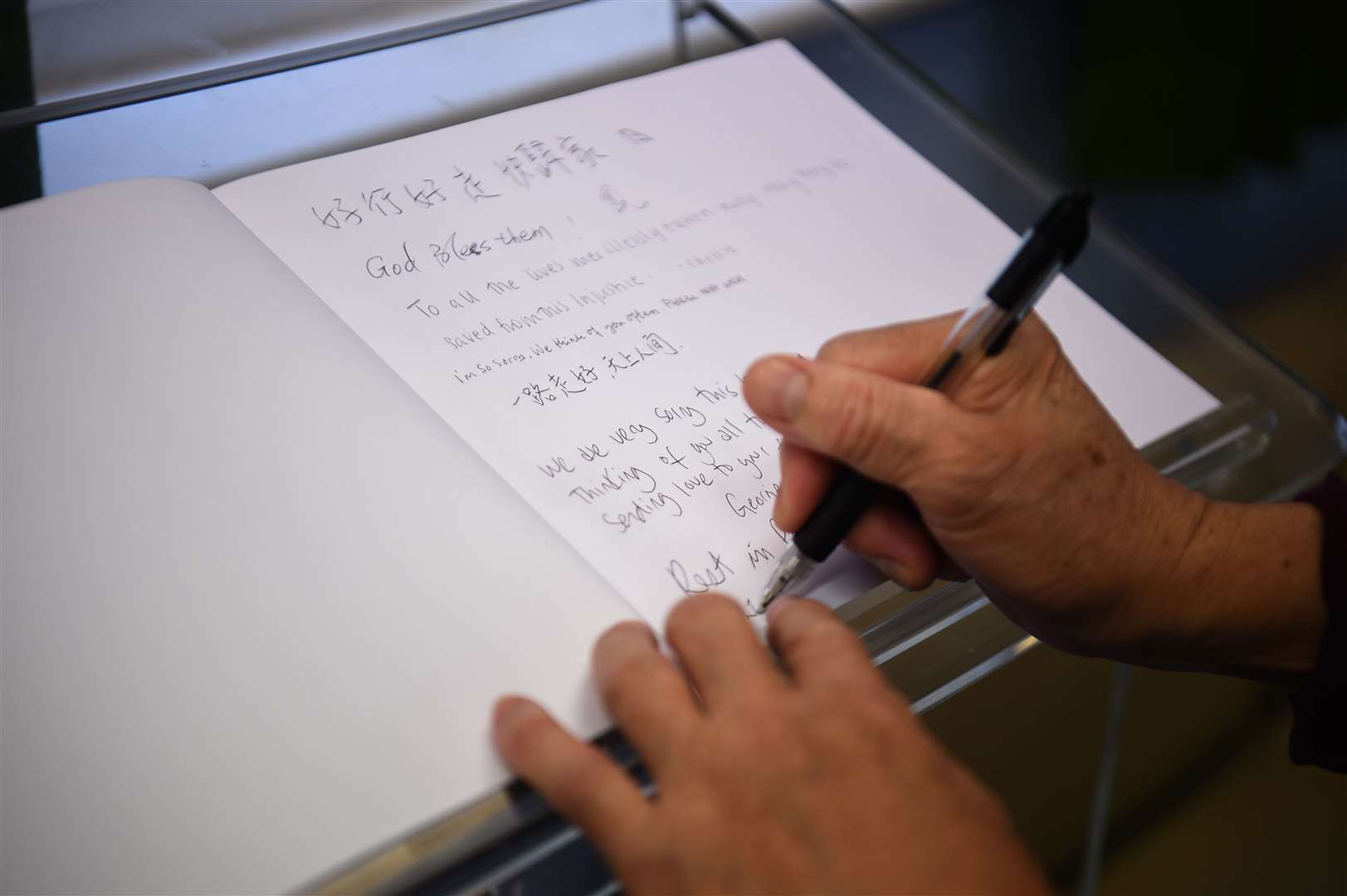 Visitors sign a book on the memorial shrine at Hackney Chinese Community Services (Kirsty O’Connor/PA)