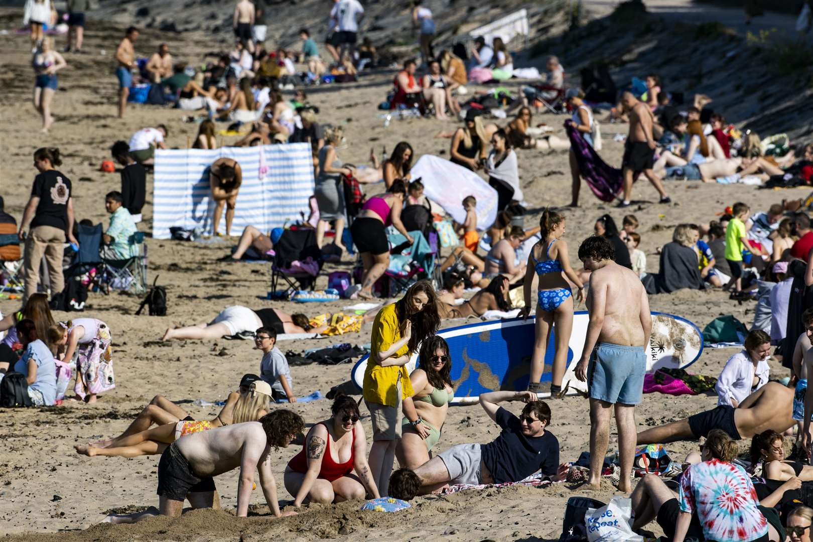 Beachgoers enjoying the warm weather at Helen’s Bay in Bangor, Northern Ireland (Liam McBurney/PA)