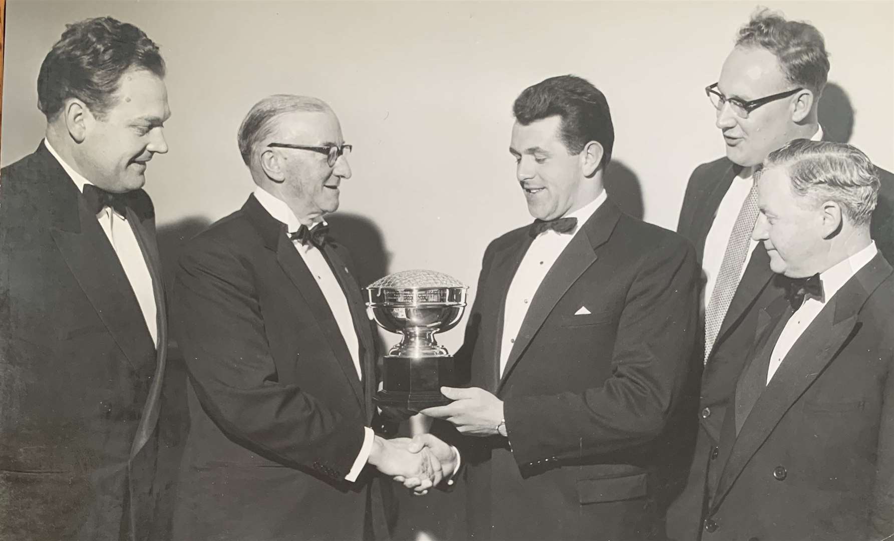 Michael Jennings is presented with the trophy by Gravesend Swimming Club members in October 1960. Picture: Michael Jennings