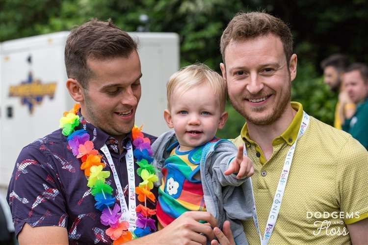 Jonathan Fitter-Harding, left, and husband, Ben, with one of their children attending Canterbury Pride