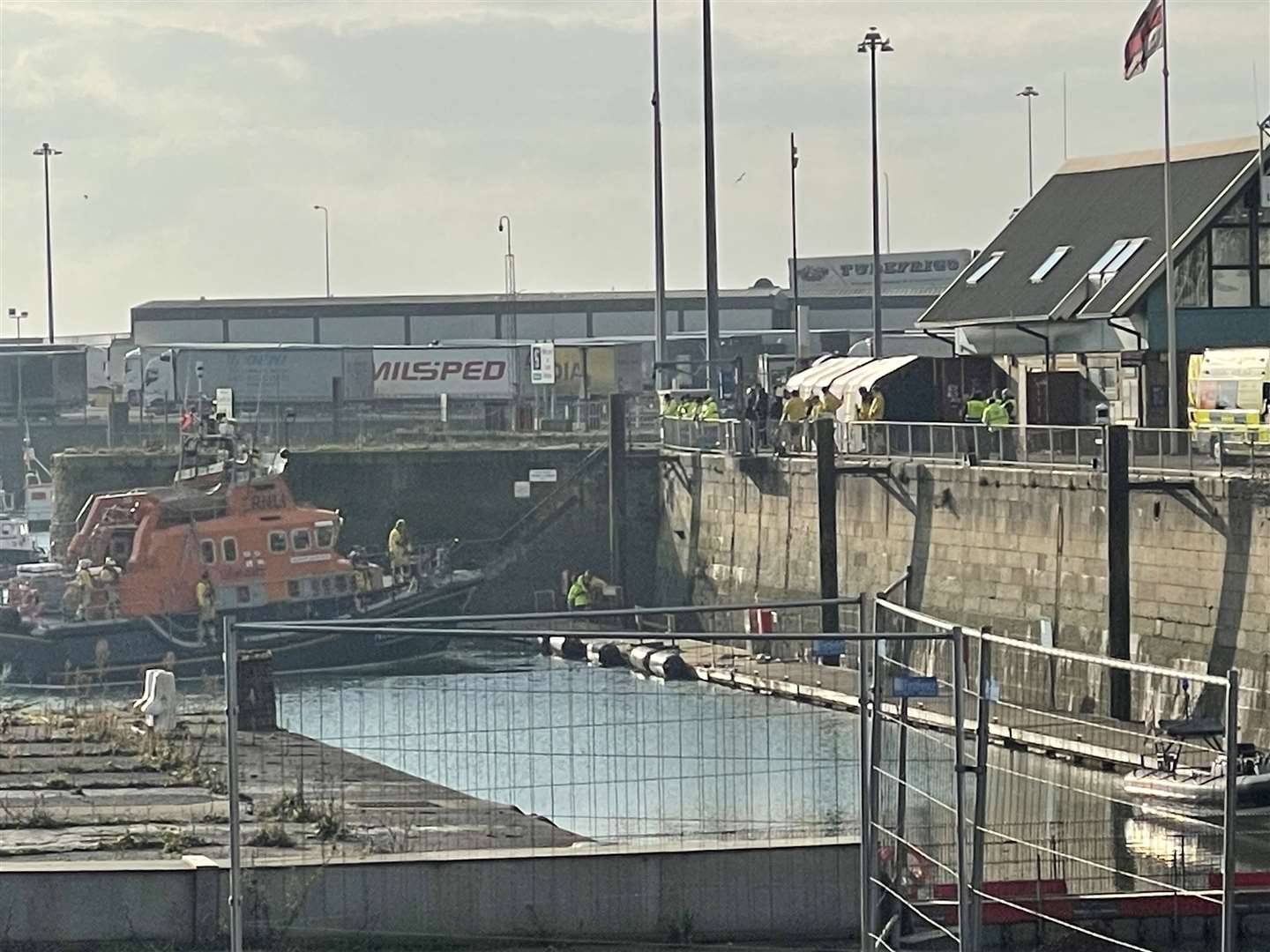 A lifeboat carrying a body returning to Dover marina