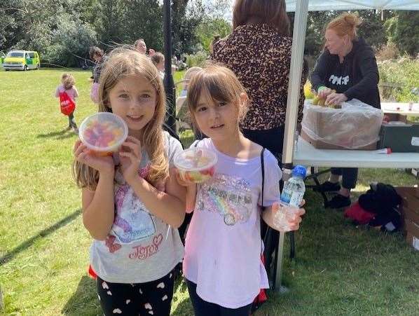 Two children presenting their fruit salad as part of a healthy eating activity