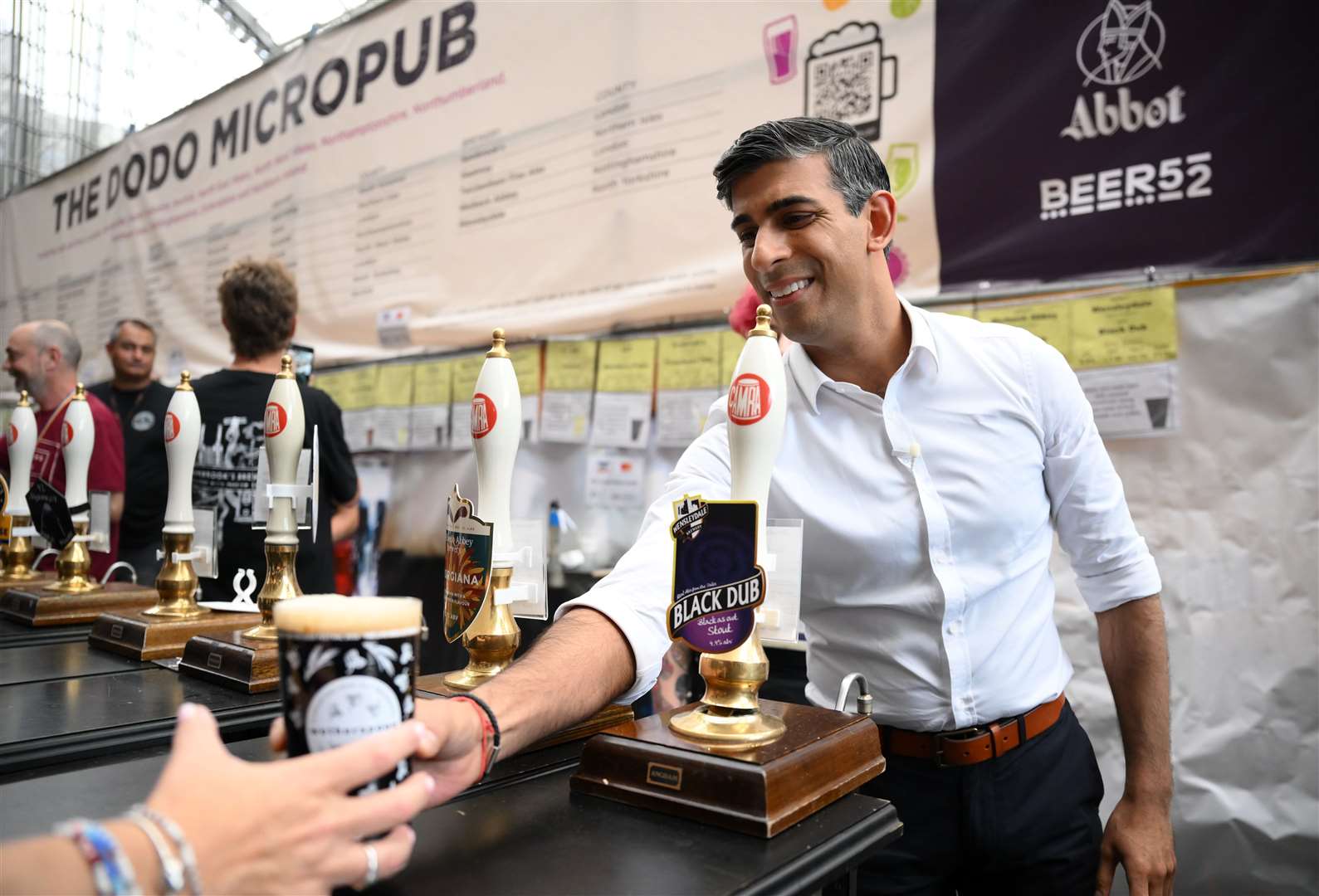 The original image of Mr Sunak pouring a pint at the festival showed him looking quite pleased with his pour (Daniel Leal/PA)