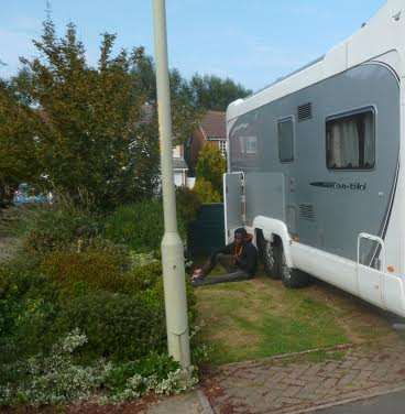 The man sat quietly next to the van waiting for police to arrive. Picture: Vicky Castle