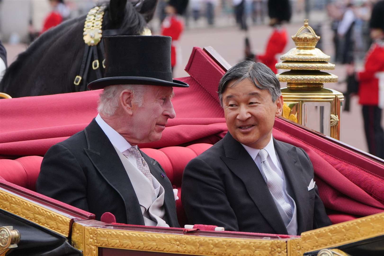Charles and Emperor Naruhito chat as they travel in a carriage to Buckingham Palace (Jonathan Brady/PA)