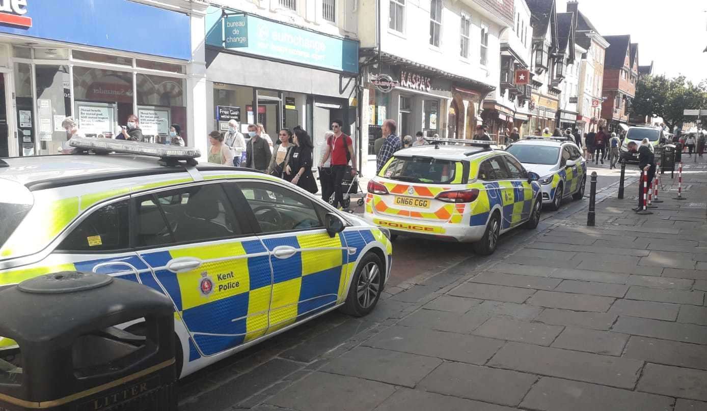 Three police cars and a police van have been spotted parked outside the Santander in the centre of Canterbury