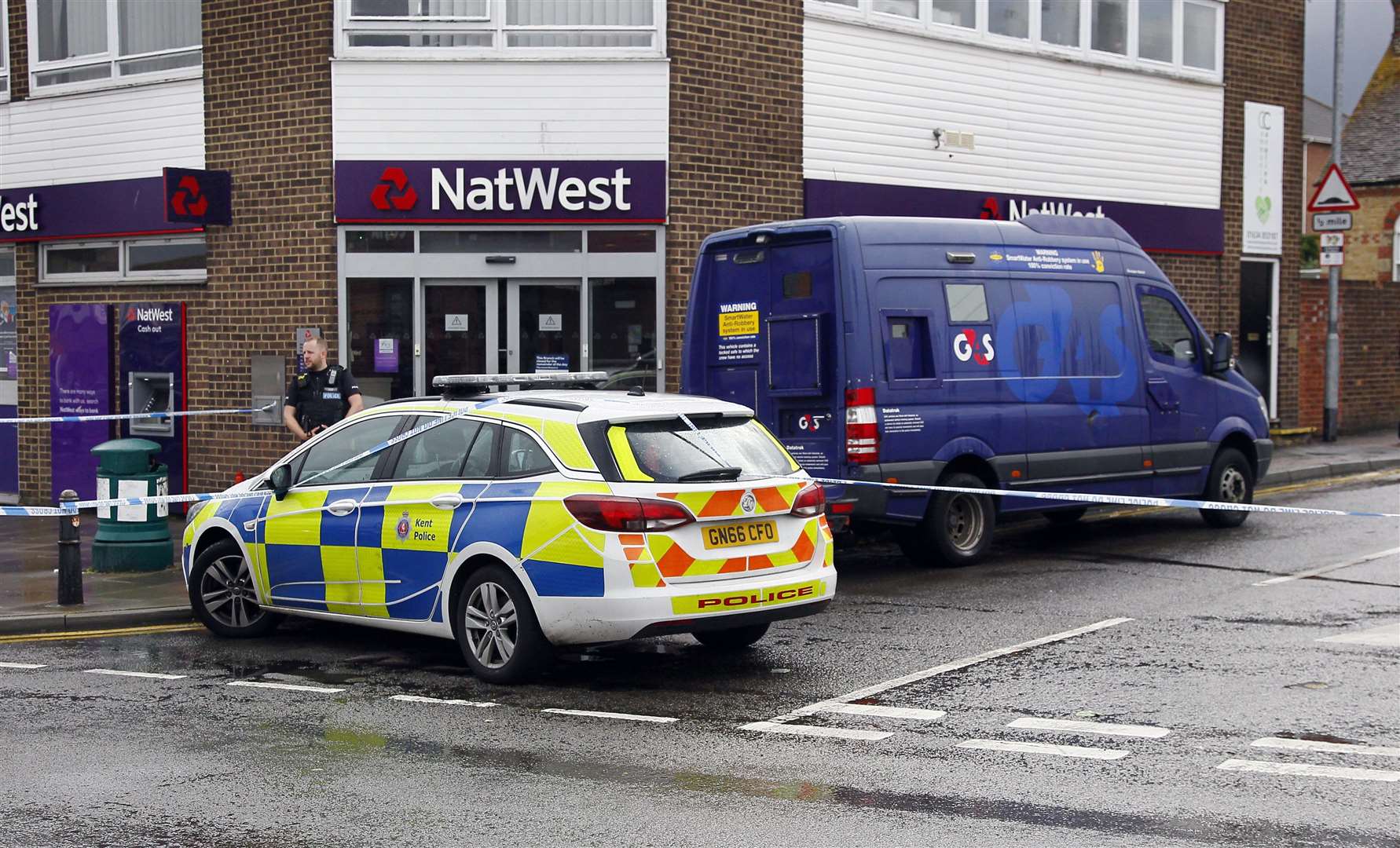 Police at the scene of the robbery at Natwest in Rainham and the G4S delivery van. Picture: Sean Aidan