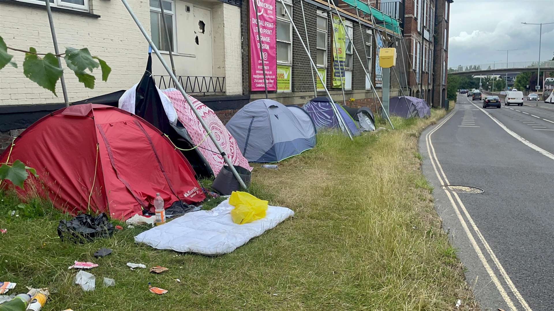 The homeless camp on the verge at the intersection of Pin Hill and Station Road East, Canterbury, right outside Catching Lives Day Centre and Club Chemistry, on the edge of the ring road