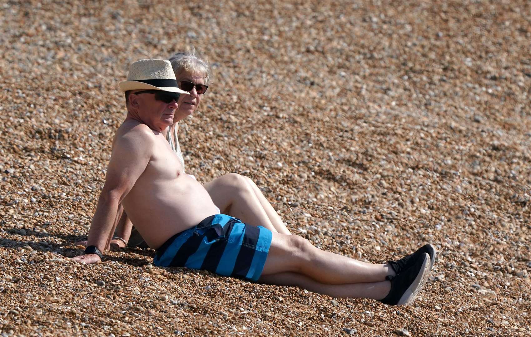 A couple enjoy the warm weather on the beach in Dover (Gareth Fuller/PA)