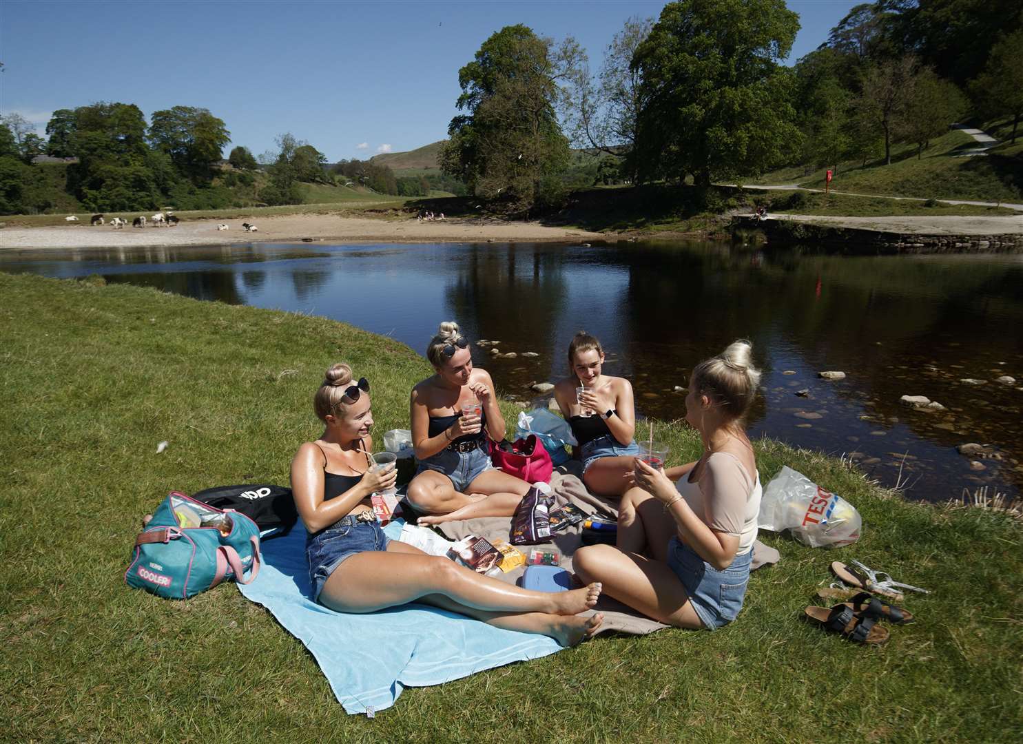 (Left to right) Kate Wormald, Lizzie Walker, Fiona Oddy and Millie Arnison enjoyed the sunshine at Bolton Abbey in North Yorkshire (Danny Lawson/PA)