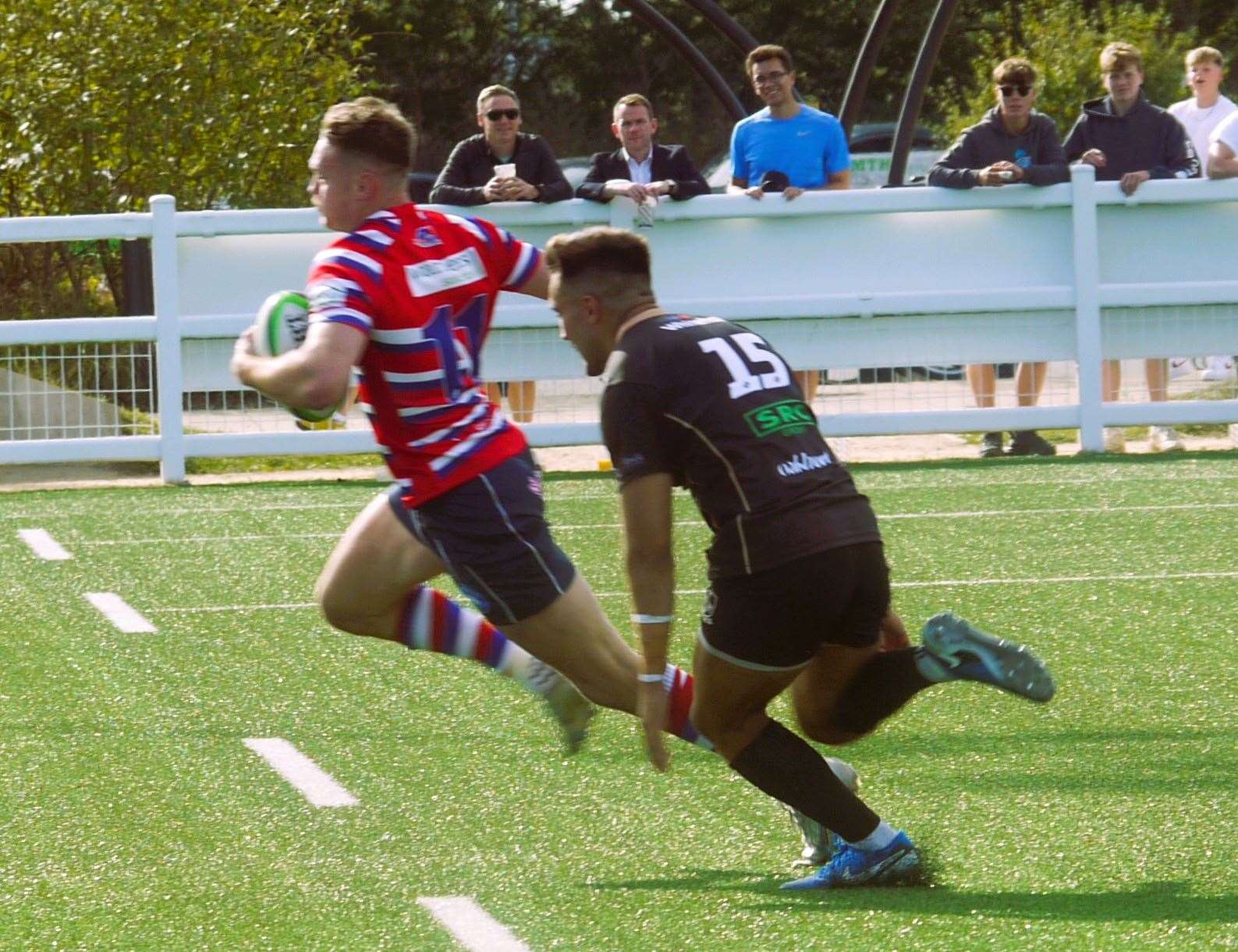 Tonbridge Juddians' Curtis Barnes speeds away from Colchester clutches. Picture: Adam Hookway