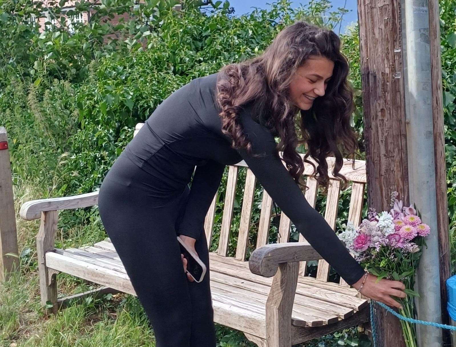 Theo's owner Ashley Hammond-Miller placing flowers under the plaque in Boughton-under-Blean. Picture: Crispin Whiting