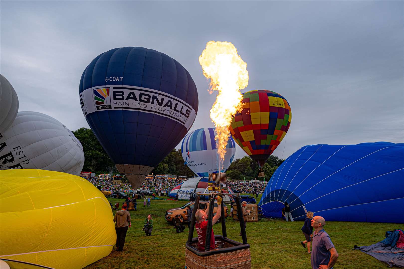 A hot air balloonist flashes the burners as he prepares to lift off (Ben Birchall/PA)