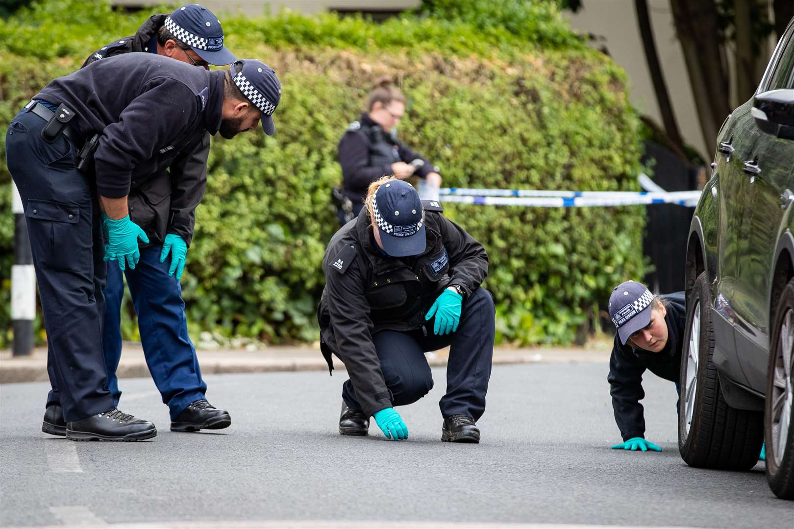 Police forensic officers looking for evidence at the scene in Energen Close, Harlesden (Aaron Chown/PA)