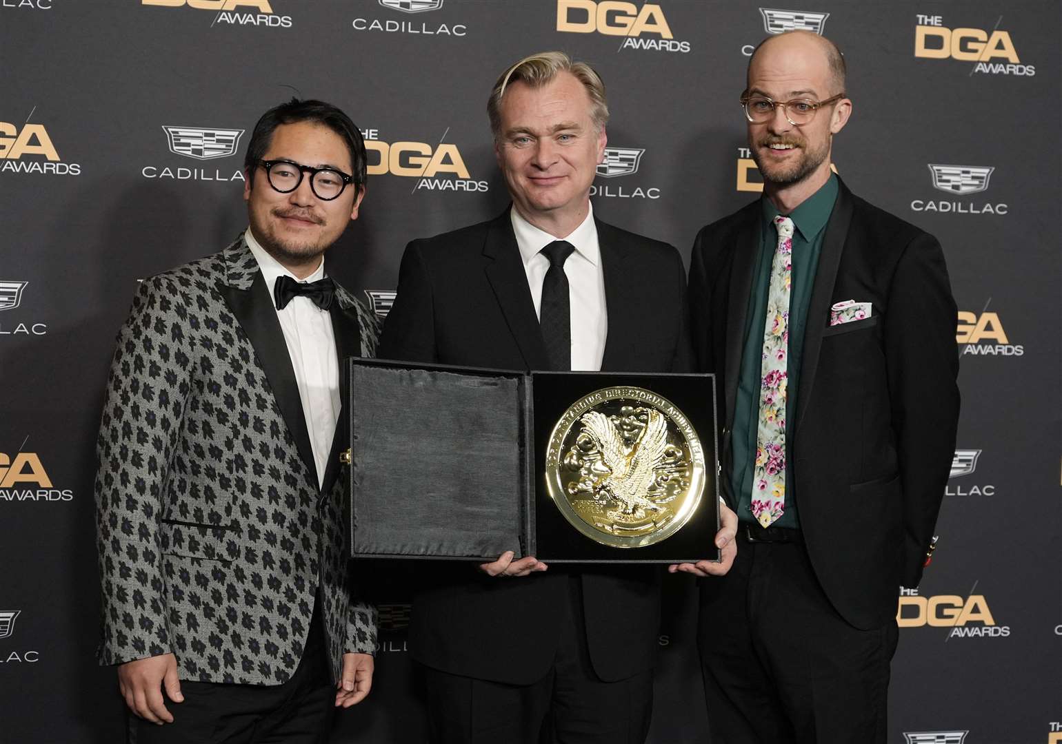 Oppenheimer director Christopher Nolan, centre, with DGA awards presenters Daniel Kwan, left, and Daniel Scheinert (Chris Pizzello/AP)