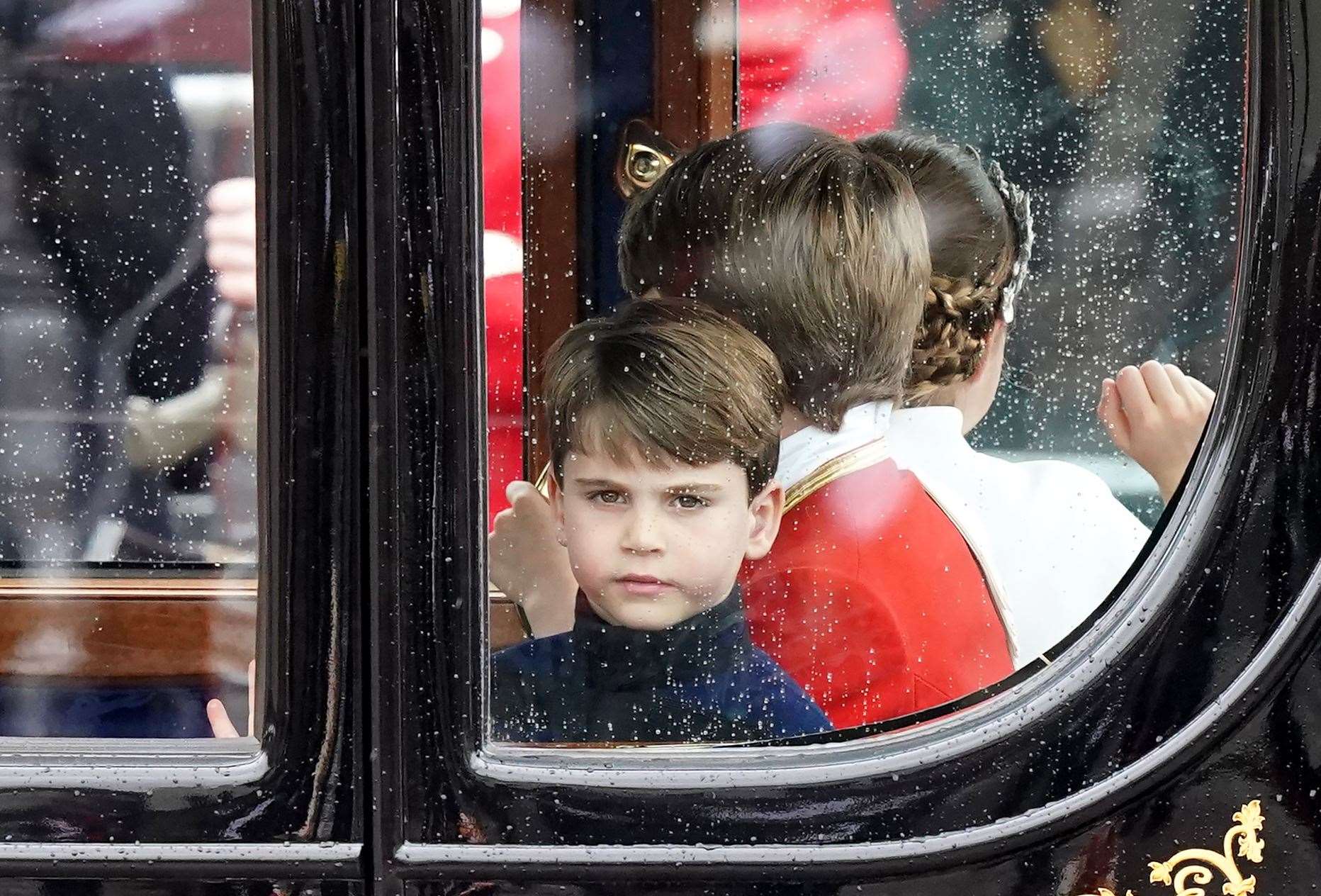 Prince Louis in the coronation procession as the royals return along The Mall to Buckingham Palace following the coronation ceremony (Niall Carson/PA)