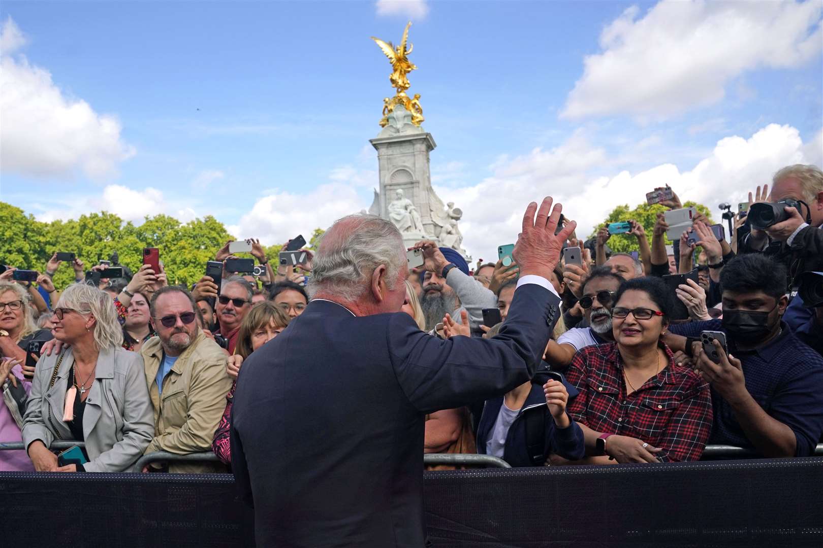 Charles waves to the crowds (Yui Mok/PA)