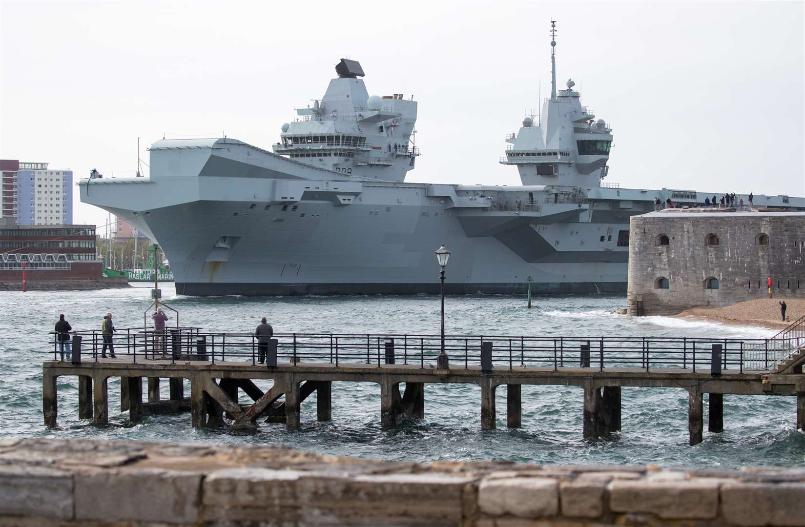 The Royal Navy aircraft carrier HMS Queen Elizabeth leaves Portsmouth harbour after being delayed due to the crew being tested for coronavirus (Andrew Matthews/PA)