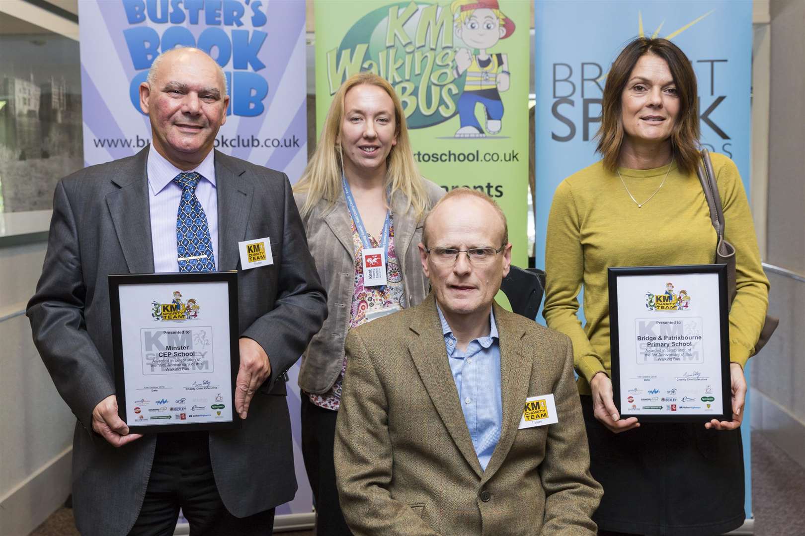 Laura Waters of KCC and Mark Styles of the KM Charity Team present Walking Bus Birthday Certificates to Bridge & Patrixbourne Primary School and Minster CEP School.