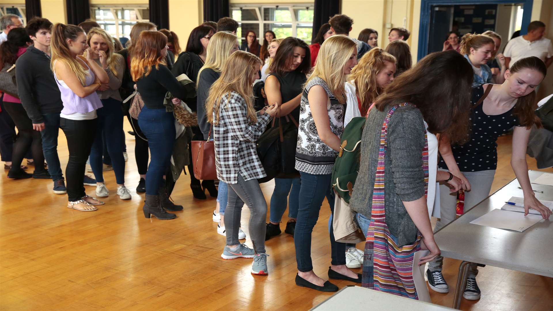 Teenagers queue to collect their results at Maidstone Grammar