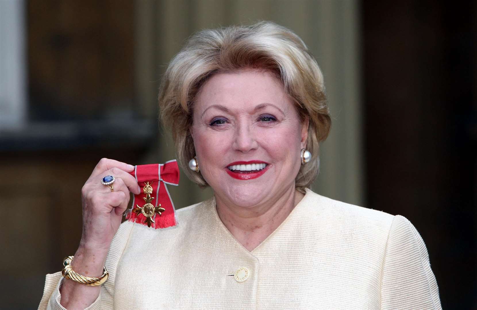 Author Barbara Taylor Bradford poses for pictures after receiving her Most Excellent Order of the British Empire from the Queen at Buckingham Palace in October 2007 (Steve Parsons/PA)