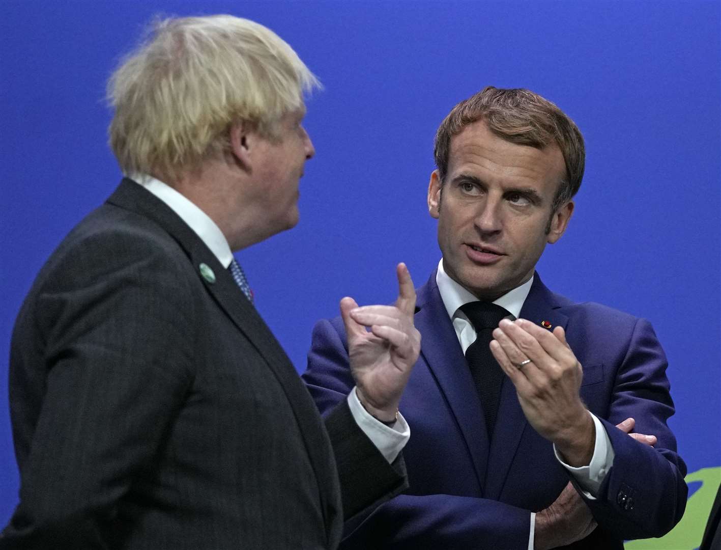 Boris Johnson greets French President Emmanuel Macron after tensions were raised over fishing rights between the two nations (Alastair Grant/PA)