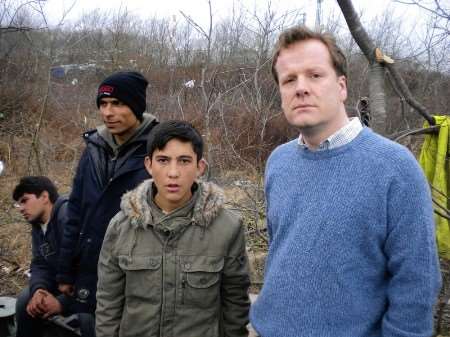 Conservative Parliamentary candidate Charlie Elphicke with a youngster at a immigrant camp in Calais