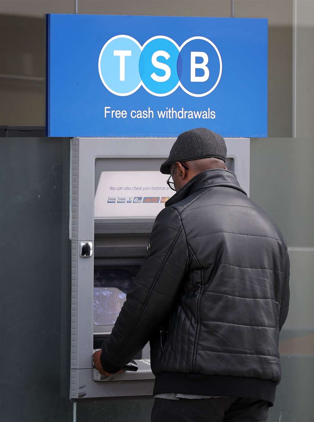 A man uses a TSB cash machine in Ashford, Kent (Gareth Fuller/PA)