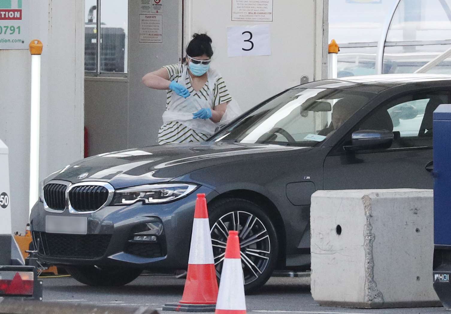 A person holds a swab at a Covid-19 drive-through test centre for NHS workers (Jonathan Brady/PA)