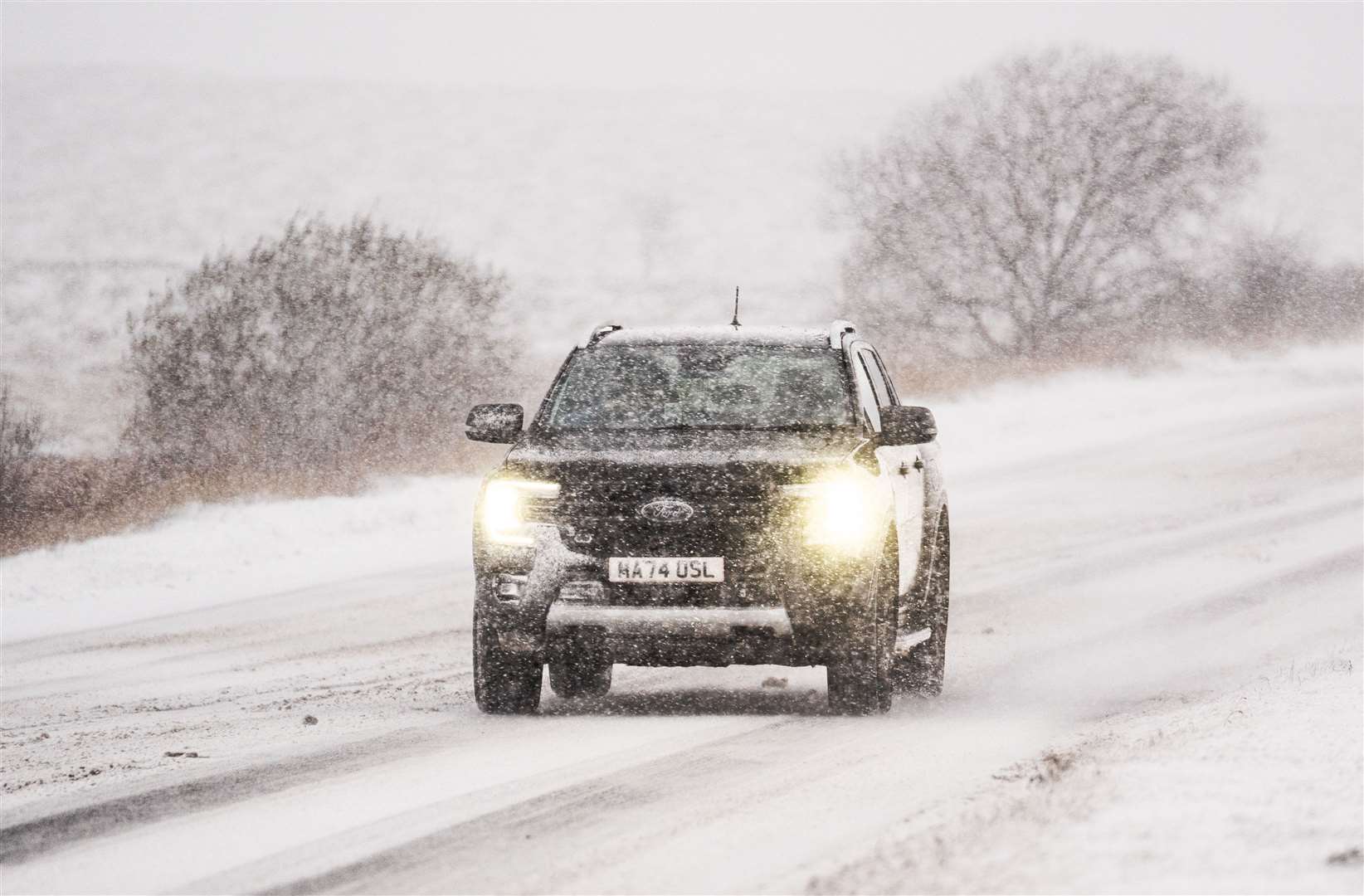 A car navigates snowy conditions on the A169 near Saltergate in North York Moors National Park (Danny Lawson/PA)